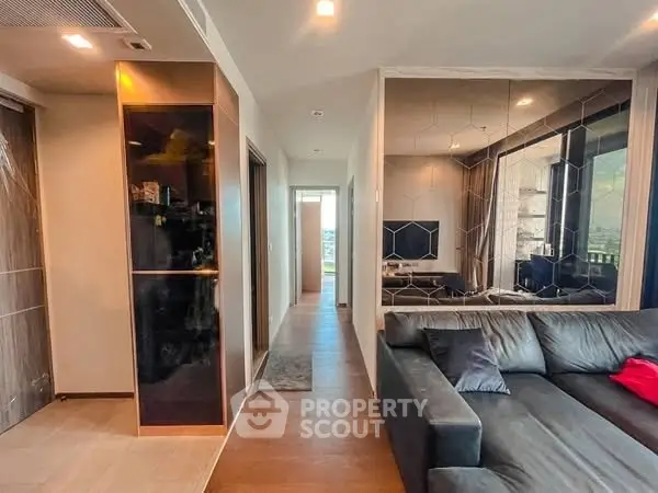 Modern living room with sleek design and large windows offering natural light and scenic views.