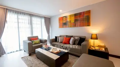 Modern living room with stylish decor and large windows for natural light.