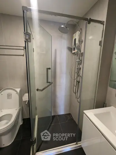 Modern bathroom with glass shower enclosure and sleek fixtures