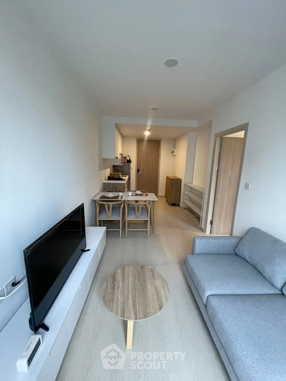 Modern living room with sleek furniture and natural light, perfect for urban living.