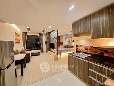 Modern open-plan living space with stylish kitchen and cozy living area, perfect for urban living.