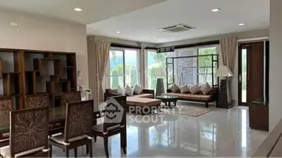 Spacious modern living room with large windows and elegant furniture