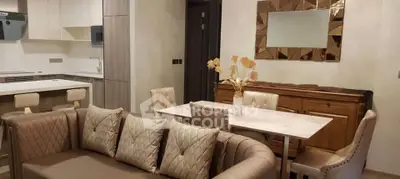 Luxurious open-plan living room with elegant decor and modern kitchen.