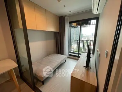 Modern compact living room with balcony view in urban apartment