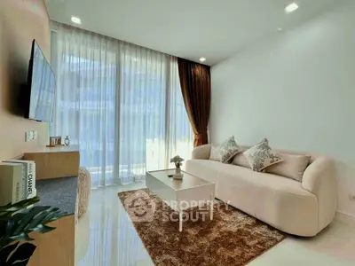 Elegant living room with modern decor, plush sofa, and floor-to-ceiling windows offering abundant natural light.
