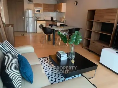 Stylish open-plan living room with modern kitchen and cozy seating area.
