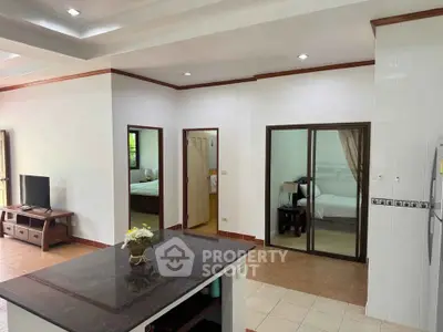 Spacious open-plan living area with modern kitchen and cozy bedrooms.