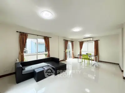 Spacious living room with modern furniture and large windows for natural light