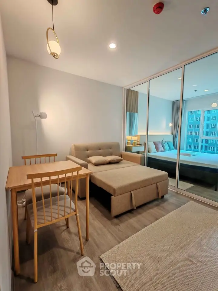 Modern studio apartment with cozy living area and stylish decor