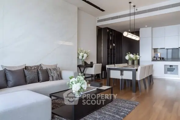 Luxurious modern living room with elegant dining area and sleek kitchen design.