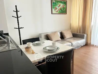 Modern living room with cozy sofa and dining area in open layout apartment.