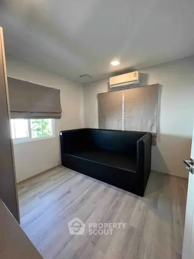Cozy small room with modern sofa and air conditioning, perfect for a compact living space.