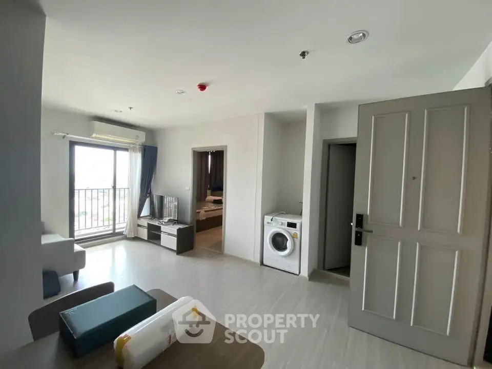 Modern apartment interior with washing machine and balcony view
