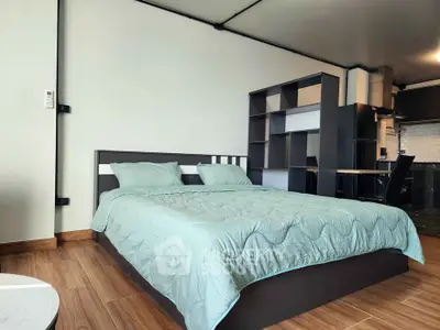 Modern bedroom with stylish decor and wooden flooring in a contemporary apartment.
