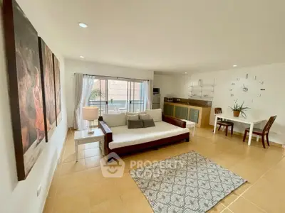 Spacious living room with modern decor and large windows for natural light.