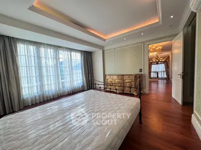 Luxurious bedroom with elegant decor and large windows in upscale property