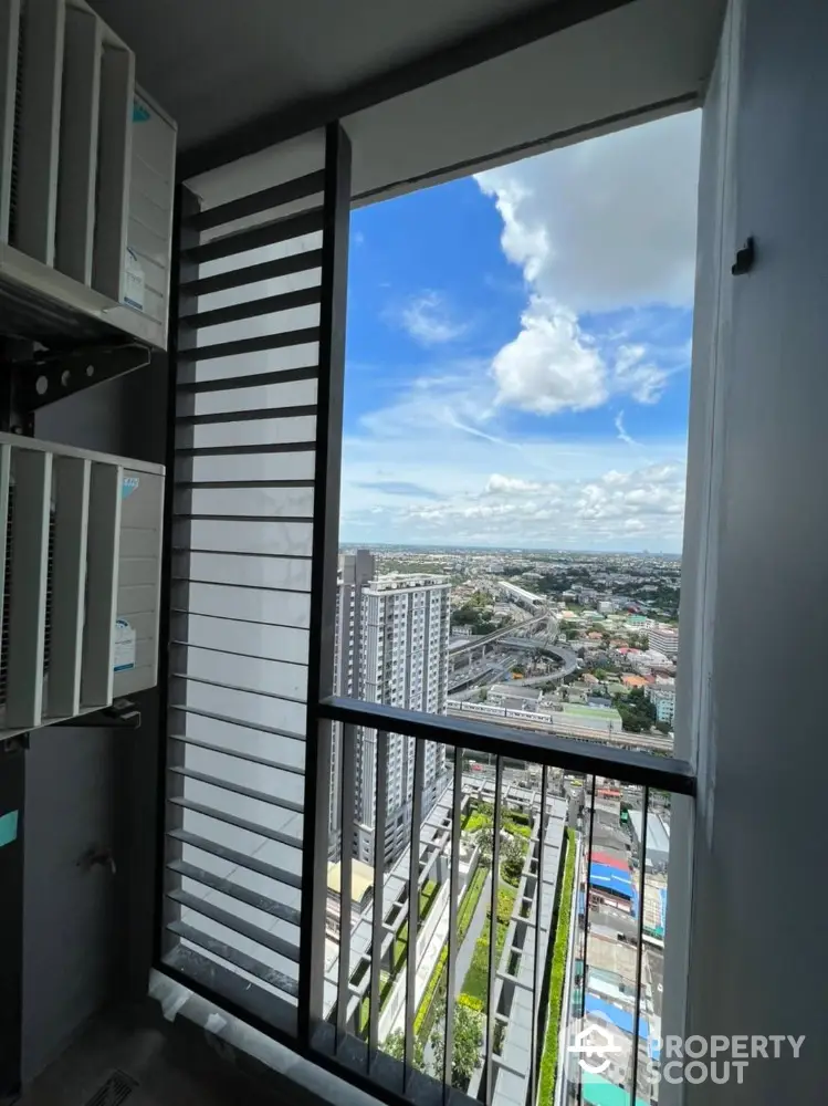 Stunning high-rise balcony view overlooking cityscape with clear blue skies.