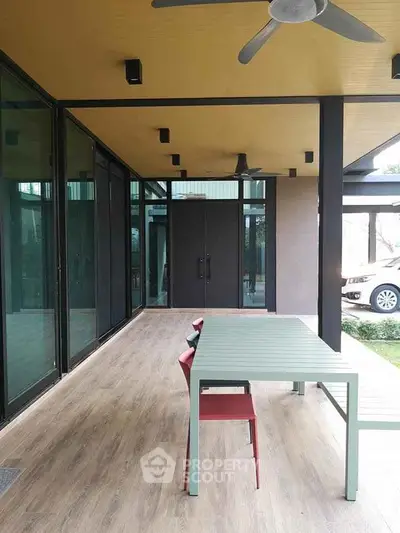 Modern patio with sleek design and outdoor dining area, perfect for entertaining.