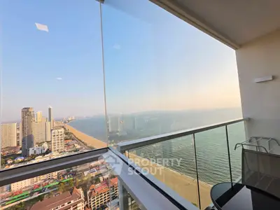 Stunning high-rise balcony with panoramic ocean and city views, perfect for luxury living.