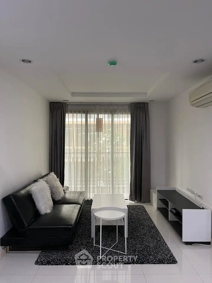 Modern living room with sleek black sofa and stylish decor