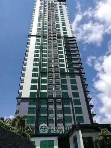 Stunning high-rise building with modern architecture against a clear blue sky.