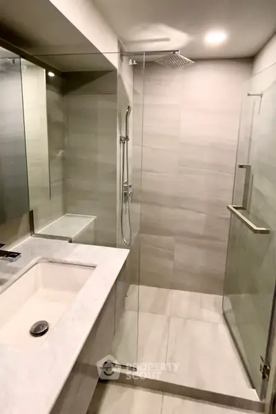 Modern bathroom with sleek glass shower and elegant marble sink