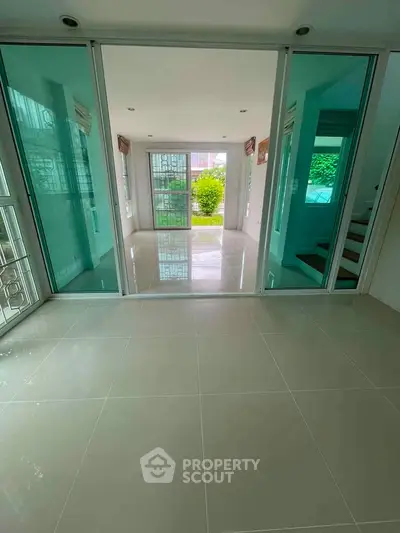 Spacious modern living room with large glass doors and garden view, perfect for natural light lovers.