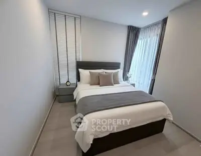 Modern bedroom with stylish decor and natural light