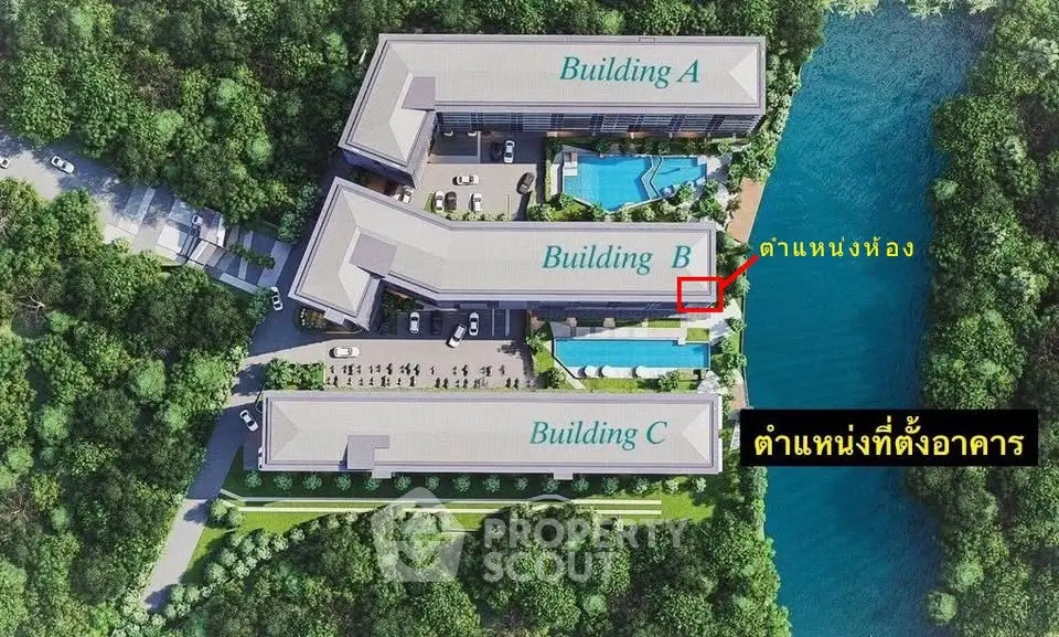 Aerial view of modern residential complex with three buildings and lush greenery.