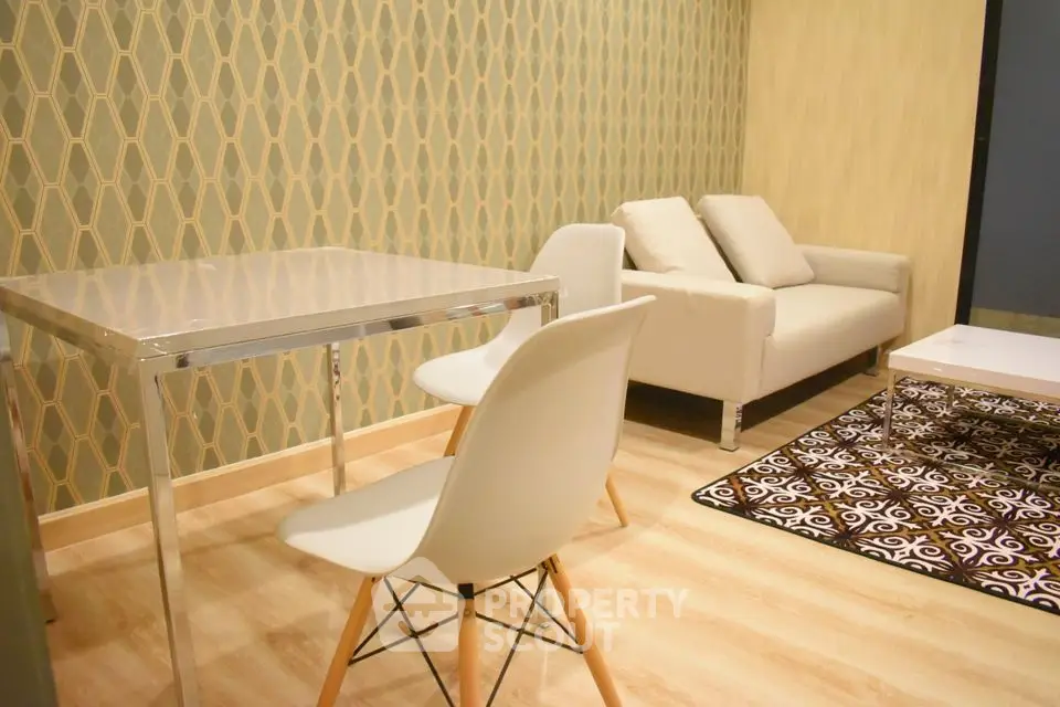 Modern living room with stylish furniture and geometric wallpaper