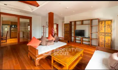 Spacious living room with elegant wooden furniture and open kitchen view