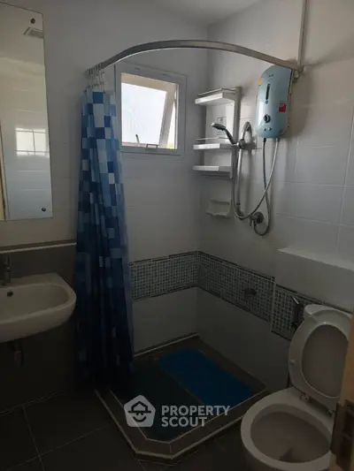 Modern bathroom with shower, sink, and toilet in compact layout