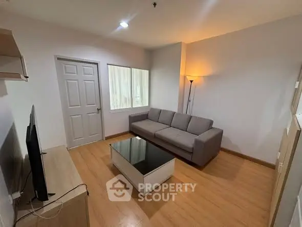 Modern living room with sleek furniture and warm lighting, perfect for relaxation and entertainment.