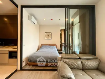 Modern bedroom with glass partition and cozy living area