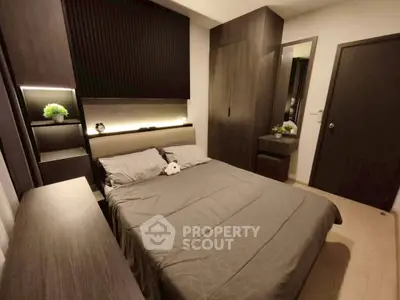 Modern bedroom with sleek design and ambient lighting, featuring a cozy bed and stylish decor.