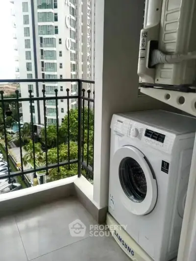 Modern apartment balcony with washing machine and city view, perfect for urban living convenience.