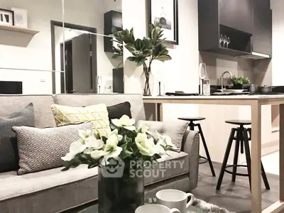 Modern living room with stylish decor and open kitchen layout, perfect for urban living.