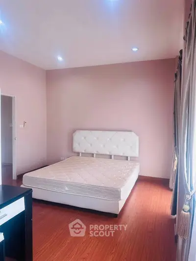 Spacious bedroom with elegant decor and natural light