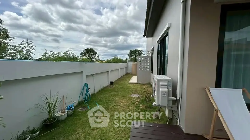 Charming backyard with lush greenery and modern exterior design, perfect for relaxation and outdoor activities.