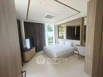 Luxurious modern bedroom with large windows and garden view, featuring elegant decor and ample natural light.
