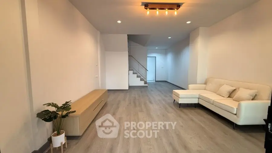 Spacious modern living room with elegant lighting and stylish furniture.