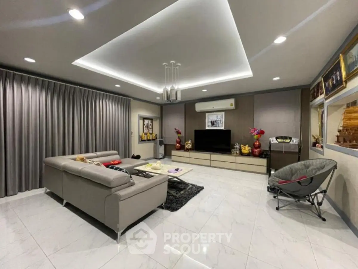 Spacious modern living room with sleek furniture and elegant lighting