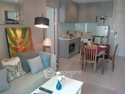 Modern open-plan living room and kitchen with stylish decor and cozy ambiance.