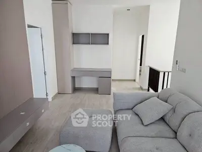 Modern living room with stylish gray sofa and built-in storage