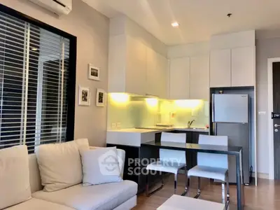 Modern open-plan kitchen and living area with sleek design and cozy ambiance.