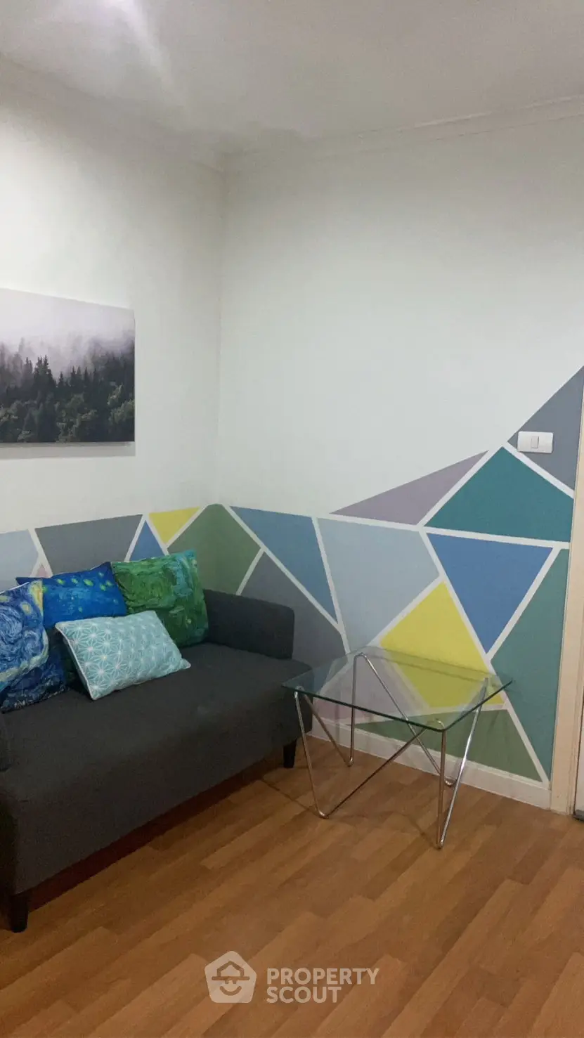 Chic living room with geometric wall design and modern furniture