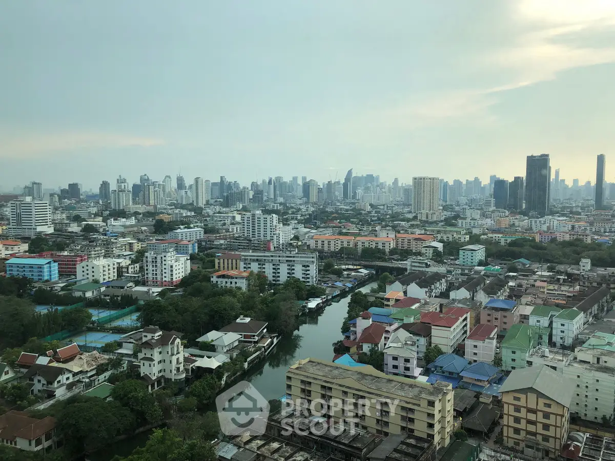 Stunning cityscape view from high-rise building overlooking urban skyline and river.