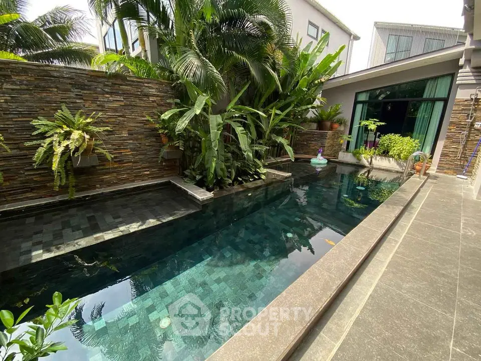 Luxurious private pool with lush greenery and modern architecture