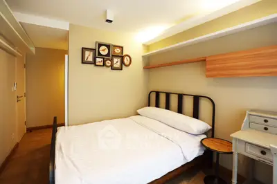 Cozy bedroom with modern decor and natural light, featuring a comfortable bed and stylish furnishings.