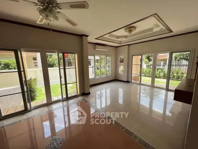 Spacious living room with large windows and garden view in modern home